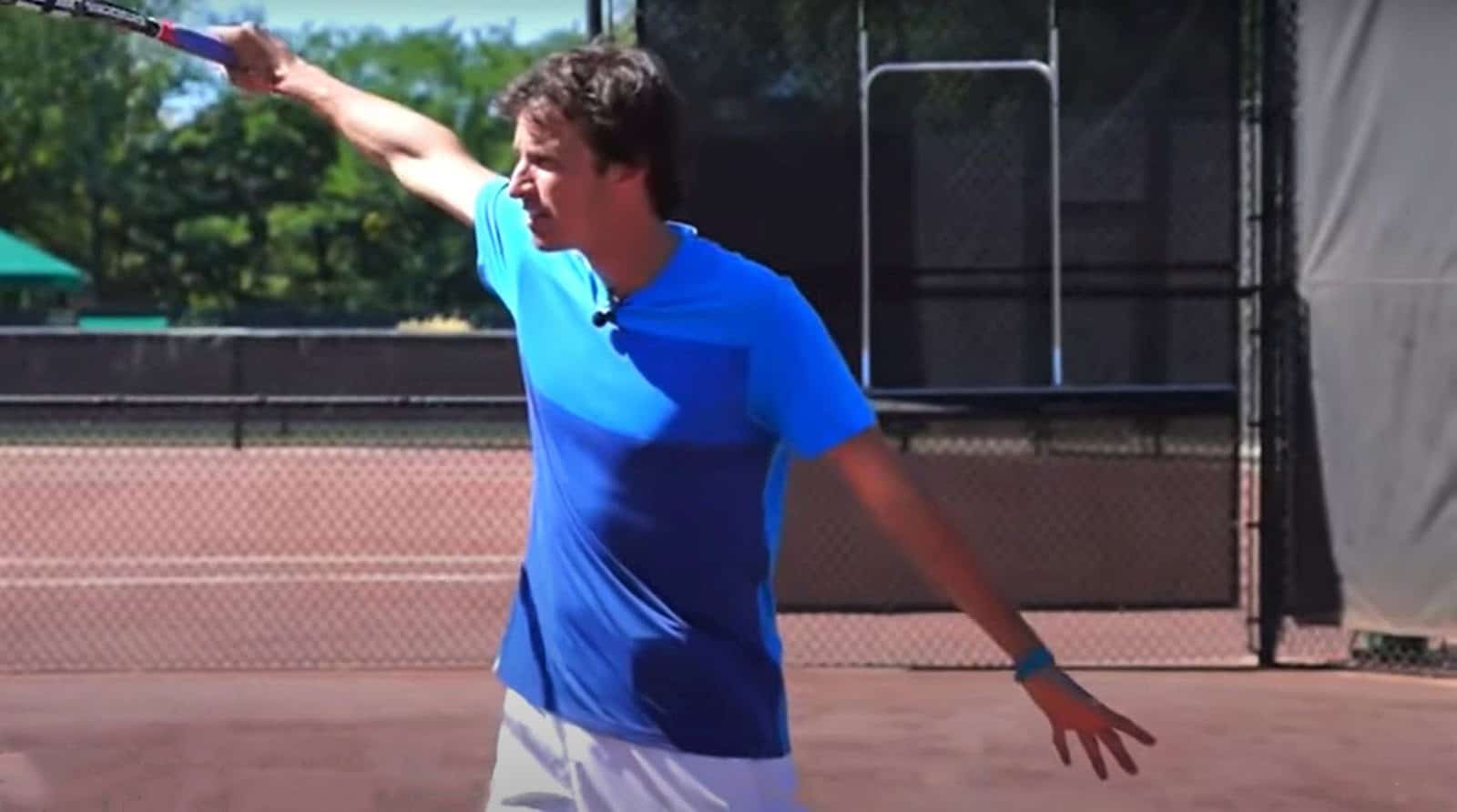 Jeff Salzenstein demonstrating a one-handed backhand slice tennis follow through