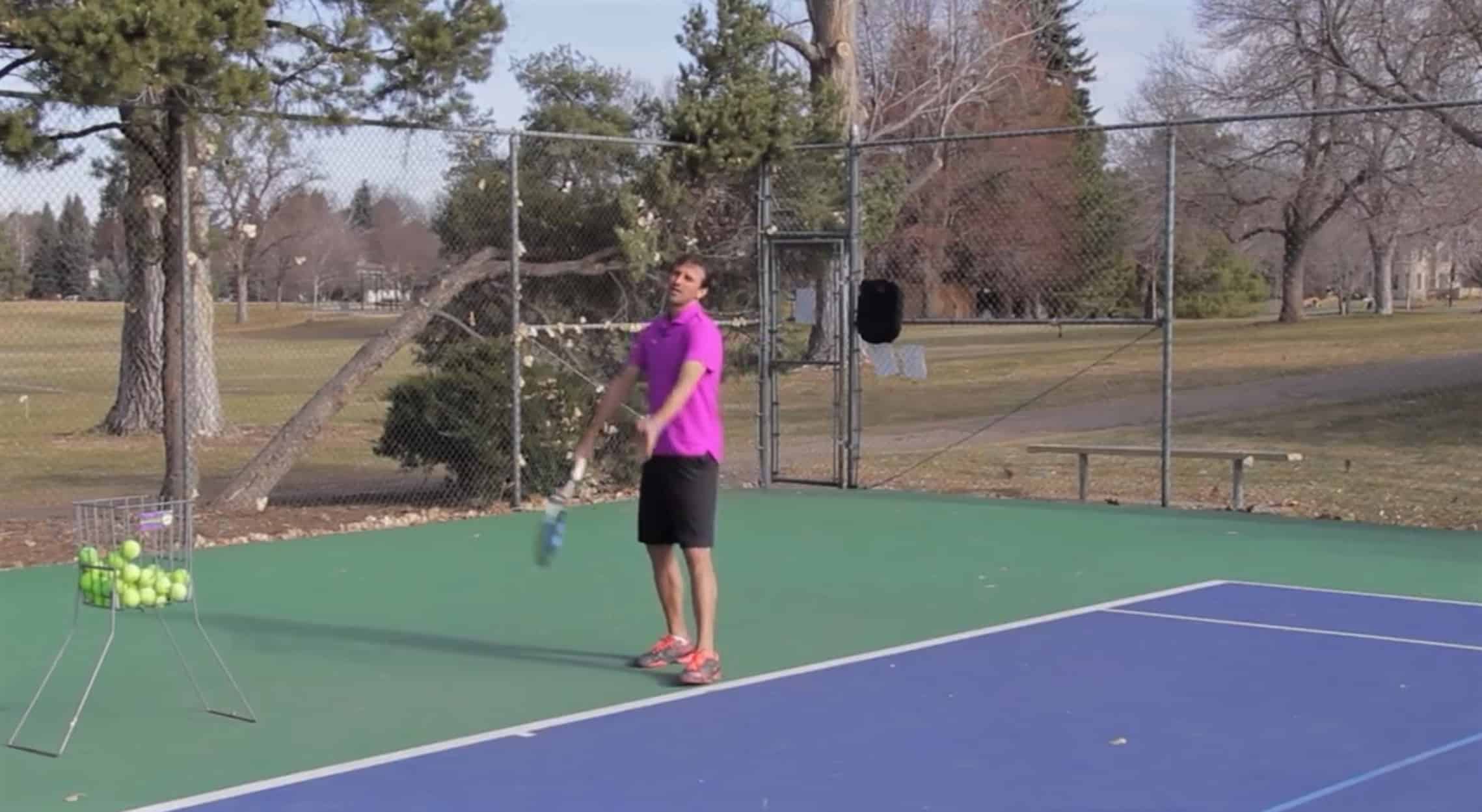Jeff Salzenstein mimicking tossing a ball for a tennis serve